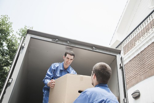 Person handling boxes carefully with proper lifting technique in a storage unit